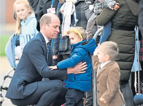  ?? ?? RISING STAR: Prince William lifts Blake Fearnley, 3, after being asked for a hug during a visit to RAF Coningsby.