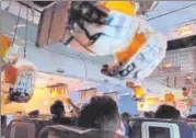  ?? REUTERS ?? ▪ Passengers reach out for oxygen masks that dropped following loss of cabin pressure on the Jet Airways flight. At least 30 out of 166 passengers experience­d nose and ear bleeding.