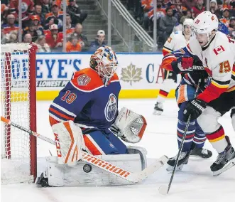  ?? JASON FRANSON/ THE CANADIAN PRESS ?? Flames winger Matthew Tkachuk is stopped by Edmonton Oilers goalie Mikko Koskinen Sunday. Despite the 1-0 loss, the Flames remain atop the Western Conference standings.