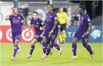  ?? STEPHEN M. DOWELL/ORLANDO SENTINEL ?? Orlando City players celebrate after Nani (17) hit the clinching penalty kick against LAFC on Friday during the MLS is Back Tournament.