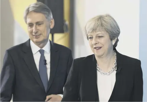  ??  ?? 0 Philip Hammond and Theresa May are being urged to ease austerity measures and end the public sector wage cap