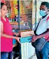  ?? ?? Pictured are representa­tives of Clogard handing over Avurudu giftpacks to members of their retailer network