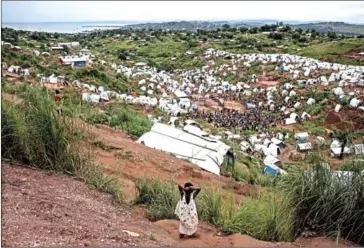  ?? JOHN WESSELS/AFP ?? A young Congolese girl looks out over a camp for internally displaced persons on March 20, in Kalemie, Democratic Republic of the Congo.