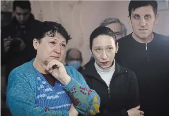  ?? THE ASSOCIATED PRESS ?? People who were evacuated from the front-line city of Bakhmut listen to the authoritie­s at a temporary housing centre in Shakhtersk, Russiancon­trolled Donetsk region, eastern Ukraine, on Thursday.