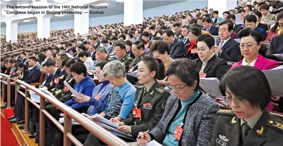  ?? ?? The second session of the 14th National People’s Congress began in Beijing yesterday. — Xinhua