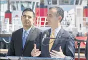  ?? Mark Boster Los Angeles Times ?? MAYOR Eric Garcetti, right, with Mayor Robert Garcia, says the pledge will hold officials accountabl­e.