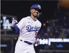  ?? AP photo ?? The Dodgers’ Mookie Betts celebrates as he rounds third base after hitting a solo home run during the sixth inning of Los Angeles’ 9-1 win over the San Francisco Giants on Wednesday.