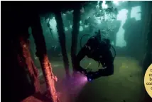  ?? — AP ?? A diver ( left) takes video while exploring a sunken boat on the Ancon coast on the outskirts of Lima, Peru, on Sunday.