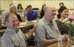  ?? CHARLES PRITCHARD - ONEIDA DAILY DISPATCH ?? Hank Leo, left, pats Jeff Leahey on the back after recieving the Roses to the Living Award during the Oneida Rotary meeting on Tuesday, June 18, 2019.