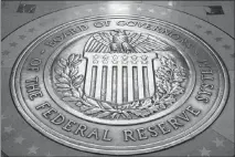  ?? ANDREW HARNIK / AP ?? The seal of the board of governors of the United States Federal Reserve System is displayed in the ground at the Marriner S. Eccles Federal Reserve Board Building in Washington. The Federal Reserve has been raising short-term rates, so the yield curve...