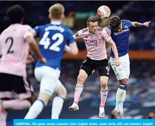  ??  ?? LIVERPOOL: File photo shows Leicester City’s English striker Jamie Vardy (2R) and Everton’s English defender Mason Holgate jump for the ball during the English Premier League football match between Everton and Leicester City at Goodison Park in Liverpool, north west England. —AFP