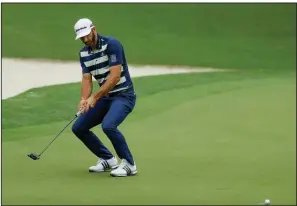  ?? AP/MATT SLOCUM ?? Dustin Johnson reacts after missing a birdie putt on the 10th hole Saturday at the Masters. Johnson and Jordan Spieth both shot 1-under par 71s in the third round, but are considered long shots to win the year’s first major.