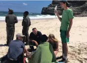  ??  ?? SAVED: Paramedics on Dias Beach, Cape Point, treat a Candian teenager rescued from drowning by a fellow teen.