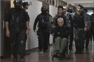  ?? MARCELO RUIZ MENDOZA — THE ASSOCIATED PRESS ?? Rev. Nicola Corradi, in wheelchair, Armando Gomez and Rev. Horacio Corbacho, are escorted out of a courtroom in Mendoza, Argentina, on Monday.