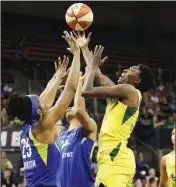  ?? ASSOCIATED PRESS ?? SEATTLE STORM’S Natasha Howard (right) and Dallas Wings’ Glory Johnson (25) reach for the ball during a game Friday in Seattle.