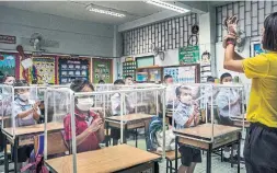  ??  ?? Students at Sawasdee Wittaya primary school in Bangkok learn about washing their hands during their first day back at school this month.