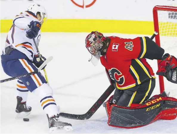  ?? AL CHAREST ?? Calgary Flames goaltender Mike Smith makes a save on Edmonton Oilers centre Connor McDavid on Tuesday in Calgary.