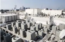  ?? Sarah Dea / The National ?? A rooftop crowded with air conditioni­ng units and satellite dishes in Dubai