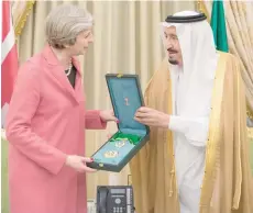  ?? — Reuters ?? Saudi Arabia’s King Salman bin Abdulaziz Al Saud honours British Prime Minister Theresa May in Riyadh.