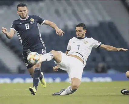  ??  ?? 0 John Mcginn vies with Russia’s Magomed Ozdoev during a 2-1 defeat. Worse was to follow against Belgium