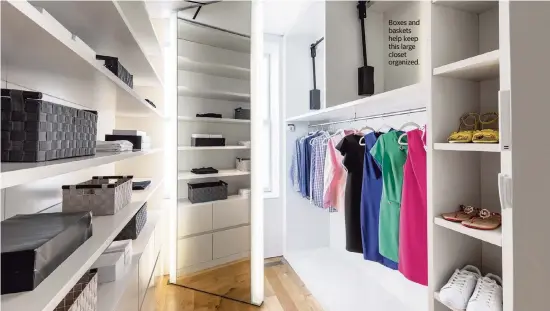  ?? Photos by Design Recipes/TNS ?? Boxes and baskets help keep this large closet organized.