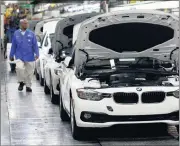  ?? PHOTO: BLOOMBERG ?? A worker walks along a line of BMW 3 Series cars as they near the end of the production line at the BMW plant in Rosslyn, Pretoria. Vehicle manufactur­ing in South Africa is threatened by envisaged empowermen­t ratings.
