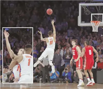  ?? AP PHOTO ?? SWEET SHOT: Chris Chiozzi lets fly with his game-winning 3-pointer in overtime, then gets hugged by Devin Robinson after Florida stunned Wisconsin last night.