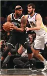  ?? (Reuters) ?? GOLDEN STATE WARRIORS Israeli forward Omri Casspi (right) defends Brooklyn Nets’ Trevor Booker in the first quarter of the Warriors’ 118-111 road triumph on Saturday night.