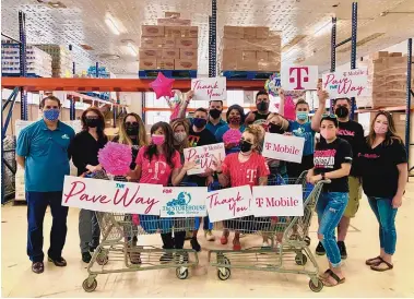  ?? COURTESY OF THE STOREHOUSE NEW MEXICO ?? Storehouse New Mexico and T-Mobile celebrate the “Pave the Way” campaign. T-Mobile raised more than $13,000 to help patch and repair the food pantry’s parking lot.