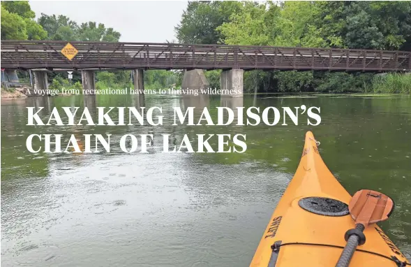  ?? BRIAN E. CLARK ?? Rain falls on the front of a Seda kayak on the Yahara River at Bjoin Park in Stoughton.