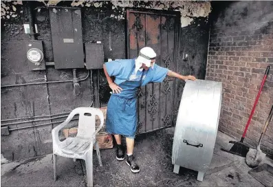  ??  ?? “Water, water and more water,” is barbecue pitmaster Robert Carpenter’s secret to survival when he’s sandwiched between the blazing hot barbecue pit and the 99-degree sun while working at The Grille, a to-go restaurant on Lamar. He also keeps an...