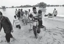  ?? Asim Tanveer/Associated Press ?? Army troops evacuate people from a flood-hit area Saturday in Rajanpur, district of Punjab, Pakistan. Officials say flash floods have killed nearly 1,000 people.