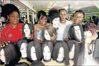  ?? Pictures: ANTONIO MUCHAVE ?? IF THE WIG FITS: Polokwane hairdresse­rs Sylvia Kamusasa, Adline Mbengo, Monica Chimbhungw­e and Vanessa Chirwana pose with their handmade wigs