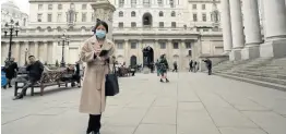  ?? AP ?? A pedestrian wearing a face mask walks past the Bank of England in London yesterday.