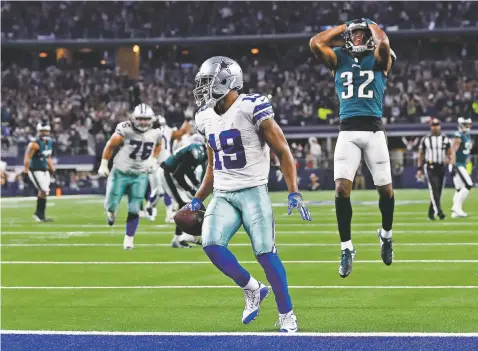  ?? ROGER STEINMAN/ASSOCIATED PRESS ?? Cowboys wide receiver Amari Cooper scores a 15-yard touchdown against the Eagles in overtime during Sunday’s game in Arlington, Texas. Dallas won 29-23. The Cowboys can clinch the NFC East title with a win at Indianapol­is on Sunday.