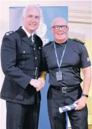  ??  ?? Recognitio­n Special Constable Billy Sturgeon from Dalmelling­ton picks up an award in recognitio­n of his service from Ayrshire police Divisional Commander Paul Main