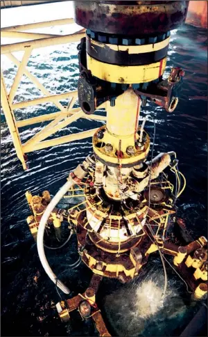  ?? Bloomberg News/u.s. Coast GUARD/THOMAS M. BLUE ?? Crew members aboard the vessel Q4000 extract the damaged blowout preventer from the Deepwater Horizon oil rig from the Gulf of Mexico on Sept. 4, 2010.