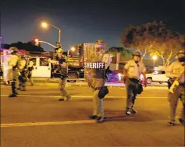  ?? Luis Sinco Los Angeles Times ?? SHERIFF’S DEPUTIES in West Hollywood on Friday. One activist decried their tactics: “We’re supposed to stay calm and relaxed when we’re getting shot at.”