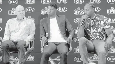  ?? RINGO H.W. CHIU/AP ?? Clippers team chairman Steve Ballmer, left, introduces Paul George, center, and Kawhi Leonard at a press conference at the Green Meadows Recreation Center in Los Angeles on Tuesday.