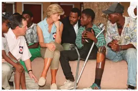  ??  ?? Helping others: Diana visits landmine victims in Angola in 1997