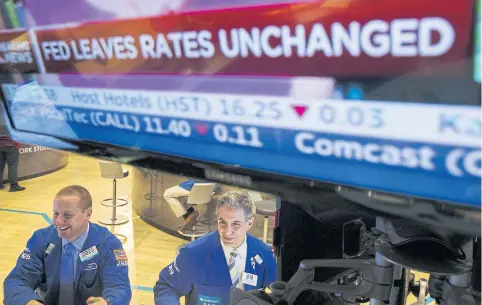  ?? REUTERS ?? Traders work on the floor of the New York Stock Exchange shortly after an announceme­nt by the Federal Reserve Bank on Wednesday.