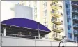  ?? Alexander Soule / Hearst Connecticu­t Media ?? Patrons enjoy drinks on the rooftop deck of Sign of the Whale in the Harbor Point district of Stamford on Jun. 30.