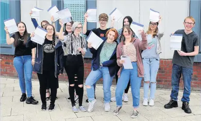  ??  ?? Students at The Grange Academy in Runcorn show their delight after receiving their GCSE results.