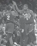  ?? JOE RONDONE/THE REPUBLIC ?? Suns guard Terrence Ross (8) high-fives teammate Josh Okogie during a game against the Clippers on Thursday.