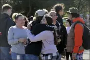  ?? BETH SCHLANKER — THE PRESS DEMOCRAT VIA AP ?? Cameron Gonzalez, 15, hugs fellow student Izzy Sullivan 18, while Cameron's mom, Amy Gonzalez, stands nearby following a fatal stabbing at Montgomery High School in Santa Rosa on Wednesday.