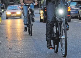  ?? FOTO: DPA ?? Bedeutende­r Unterschie­d: Ein Fahrradfah­rer ohne Licht und ein Fahrradfah­rer mit Licht.