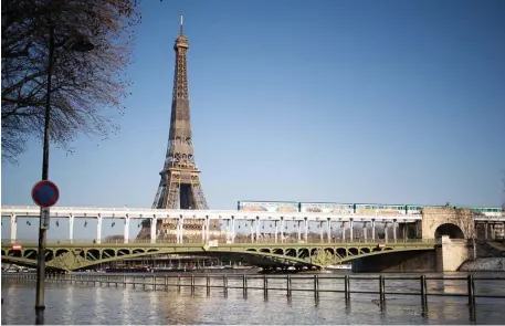  ?? TNS ?? STANDING GUARD: It could be a while before Americans get to take in the Seine and Eiffel Tower in person.