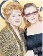  ?? GETTY IMAGES FILE ?? Debbie Reynolds, left, with daughter Carrie Fisher, in Los Angeles in 2015.