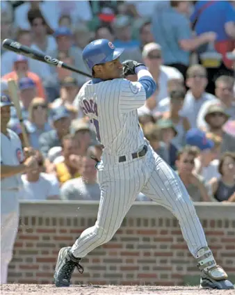  ??  ?? Above, Sosa crushes one of the 20 home runs he hit in June 1998 at Wrigley Field. Top right, McGwire gets a hug from Sosa after breaking the single-season home-run record with his 62nd on Sept. 8, 1998, against the Cubs in St. Louis. Bottom right, McGwire and Sosa sit on a cart after a news conference on Sept. 7, 1998, in St. Louis.