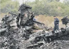 ??  ?? Wreckage of flight MH17 hadf to be retrieved from a war zone